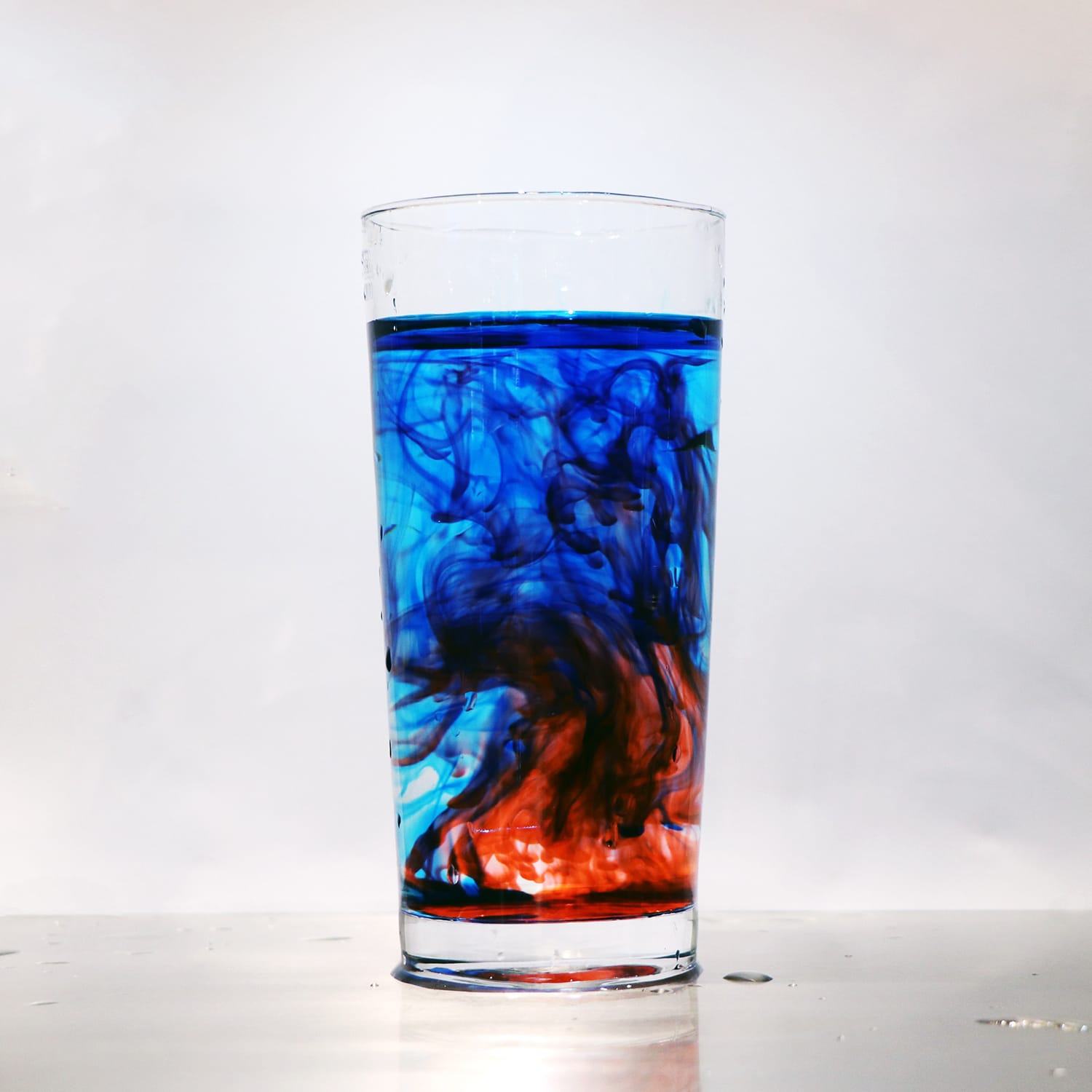 Photograph the whimsy of colored liquids using food dye and a glass of water