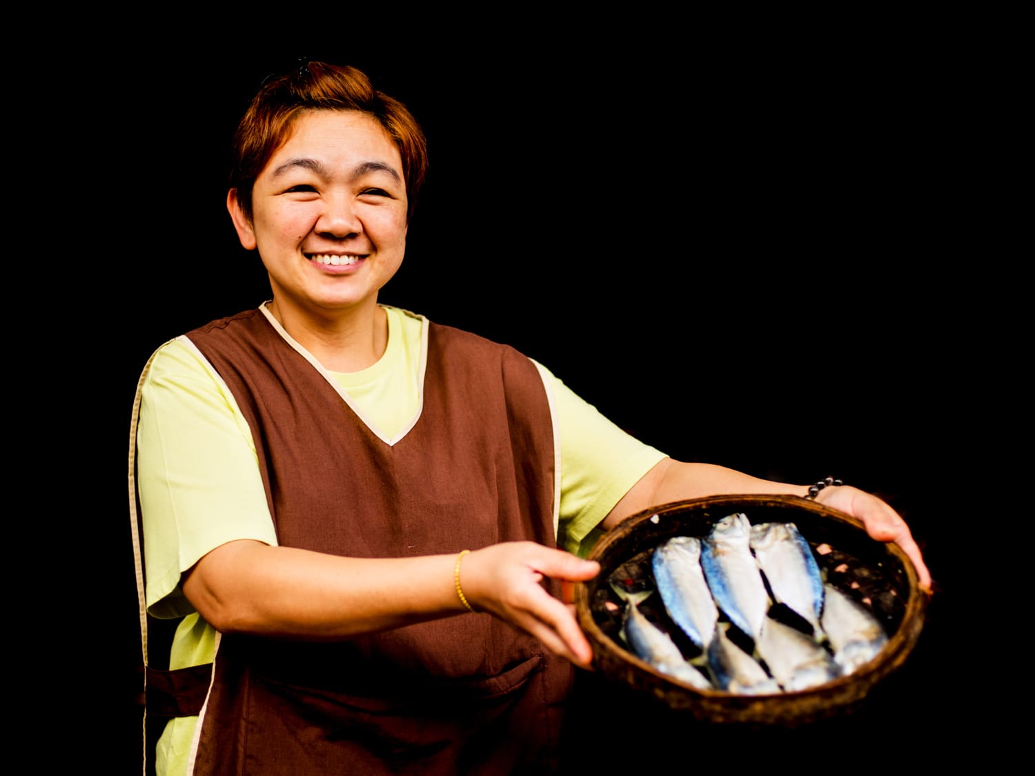 Fish vendor at a fresh market in Chiang Mai, Thailand