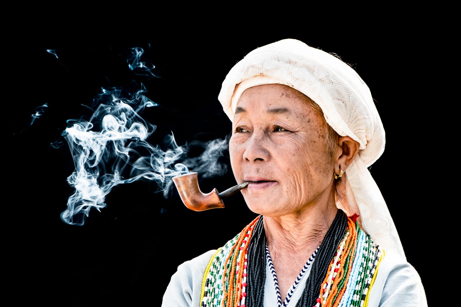 Karen woman smoking a pipe against a black background