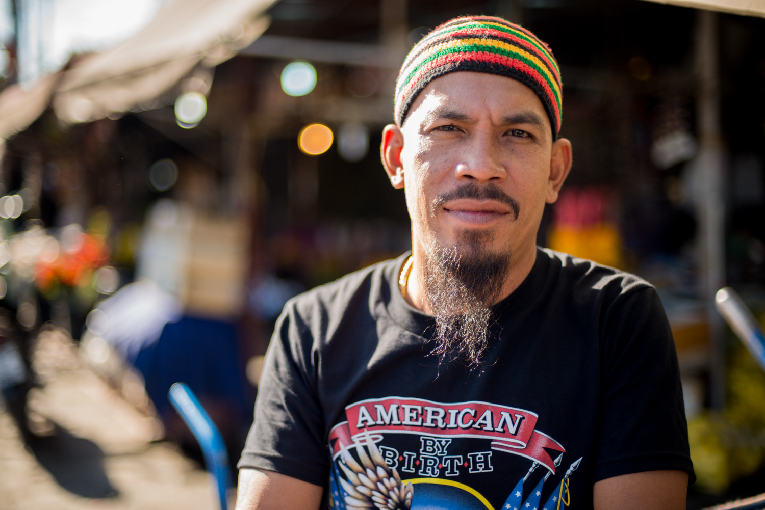 Thai man wearing a beanie and black shirt