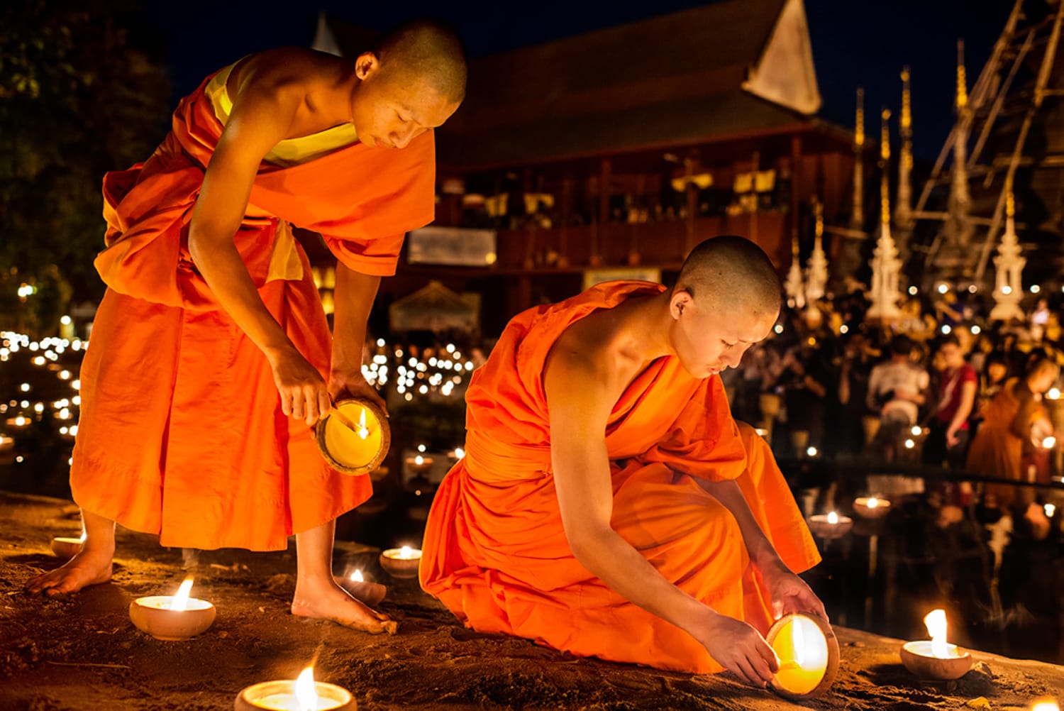 Young monks light candles during the Macha Pucha celebration at at Wat Pan Tao, Chiang Mai, Thailand, Asia.