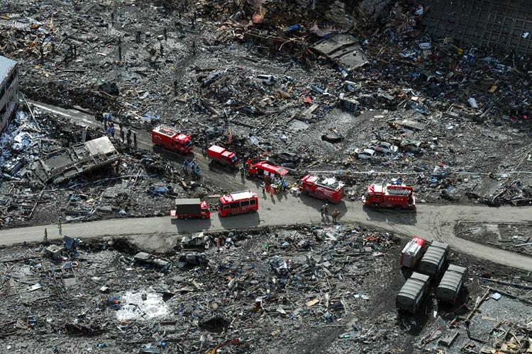 Emergency vehicles search for victims of earthquake/tsunami.