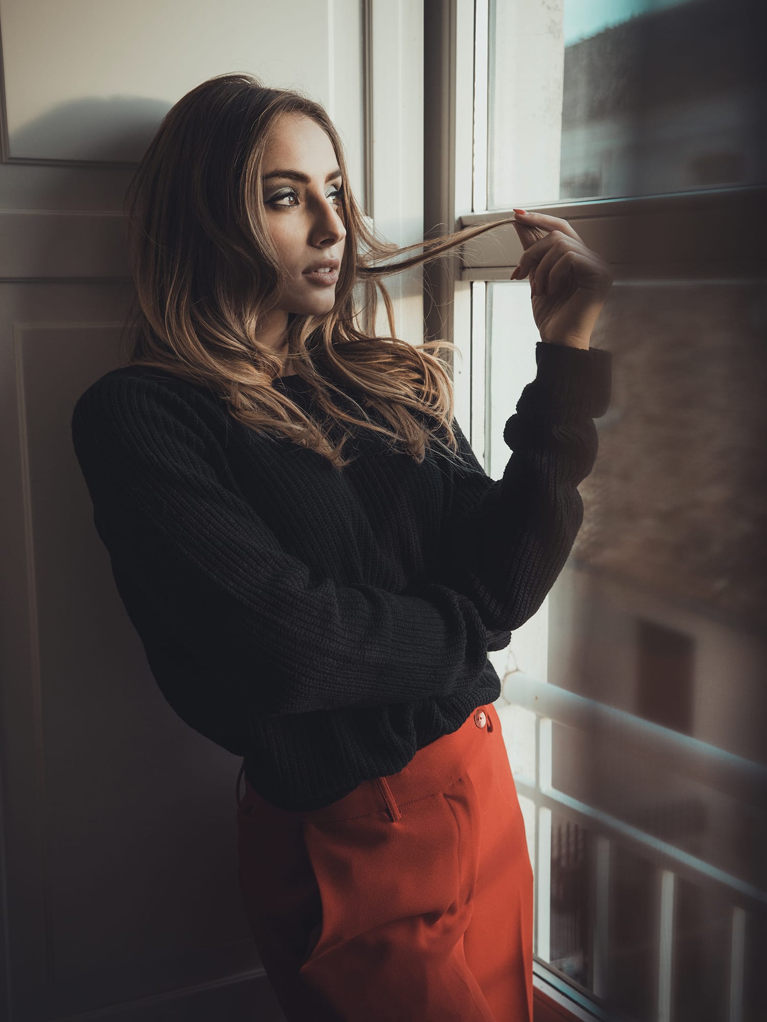 Portrait of serious brunette female with healthy skin, looks confidently at  camera, has dark straight hair, isolated over grey studio background.  Pretty young blue eyed woman poses indoor alone Stock Photo by ©