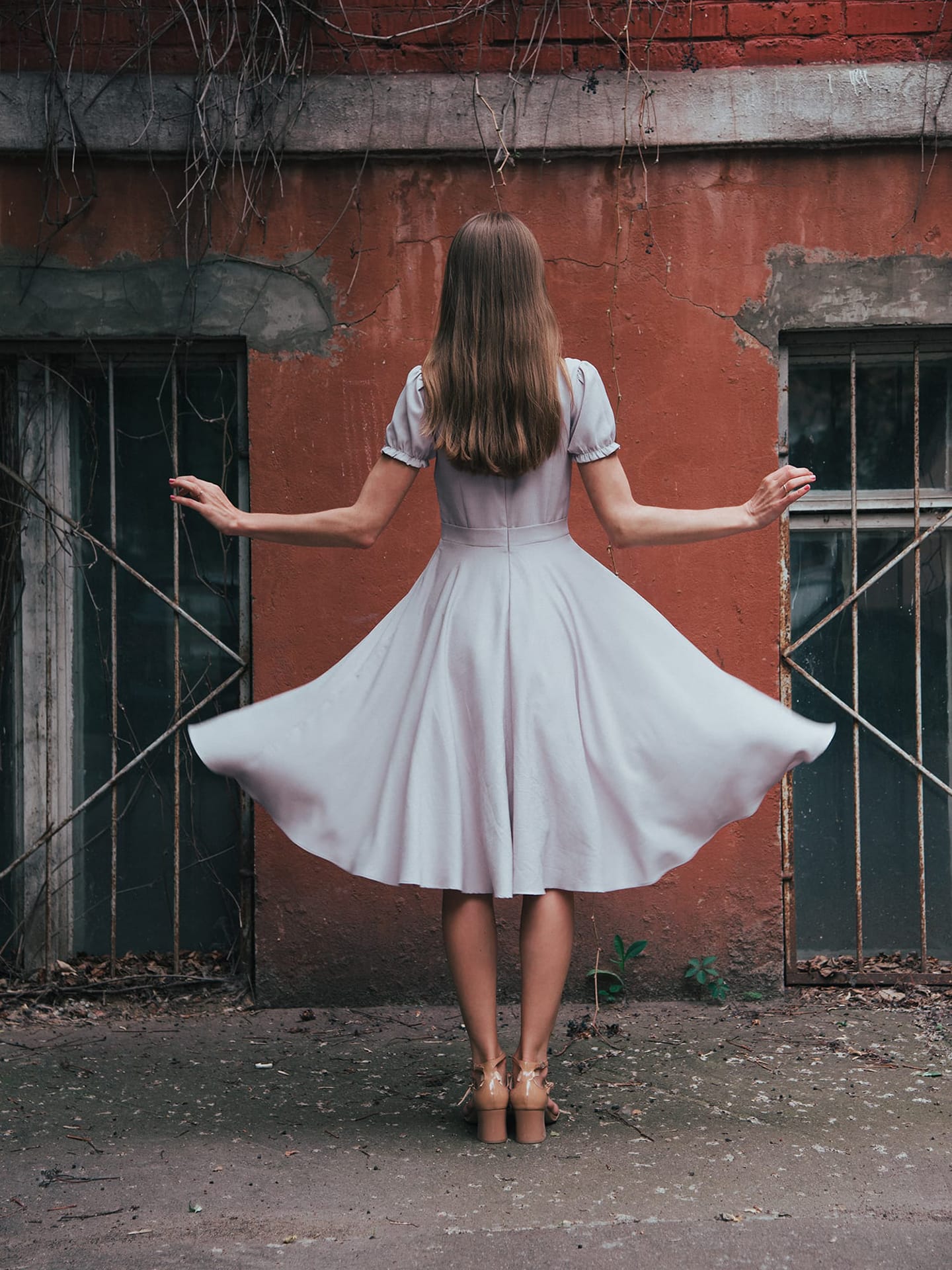 Beautiful model posing in sexy dress at black studio Stock Photo by  svittlana