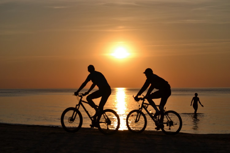 couple biking at sunset